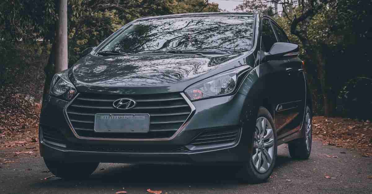 Black Hyundai Car Parked on the Road Between Trees