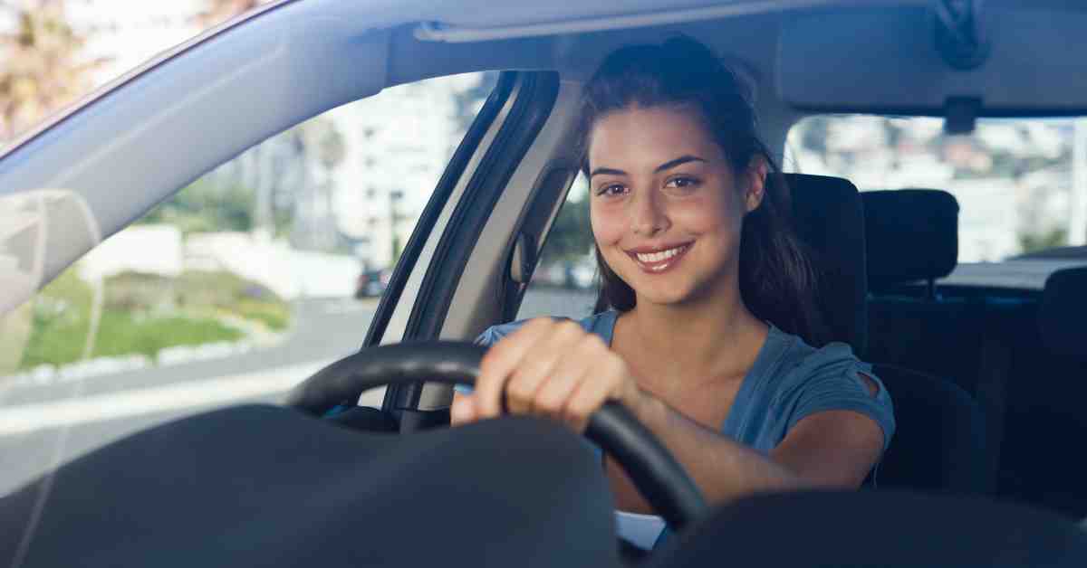 Woman driving car with smile