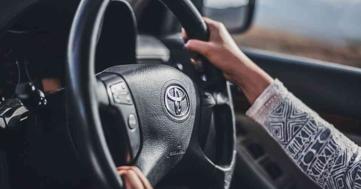 a lady holding toyata car