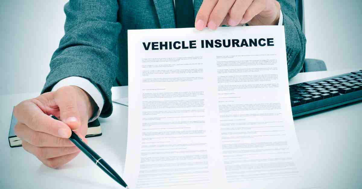 Young Man in Suit Showing a Vehicle Insurance Policy